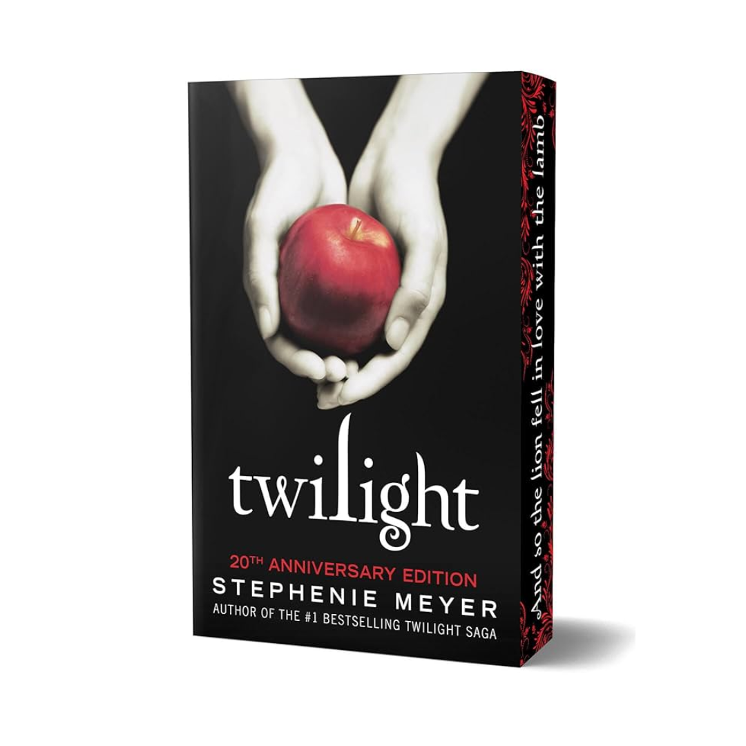 Book cover of 'Twilight' with hands holding an apple on a black background